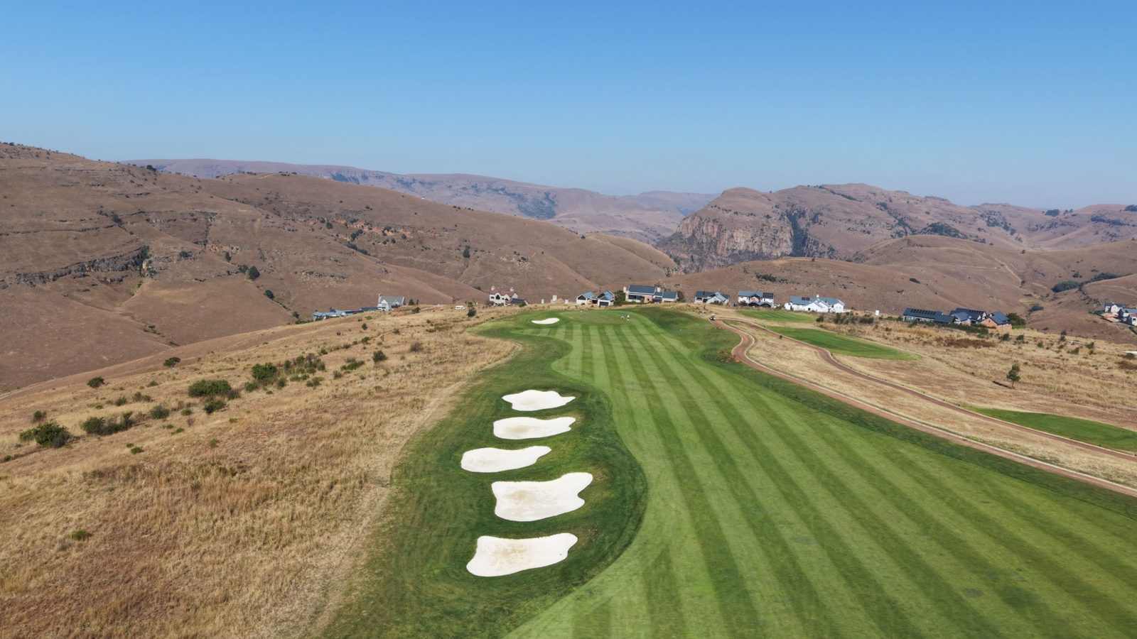 Highland fairway with bunkers and distant hills