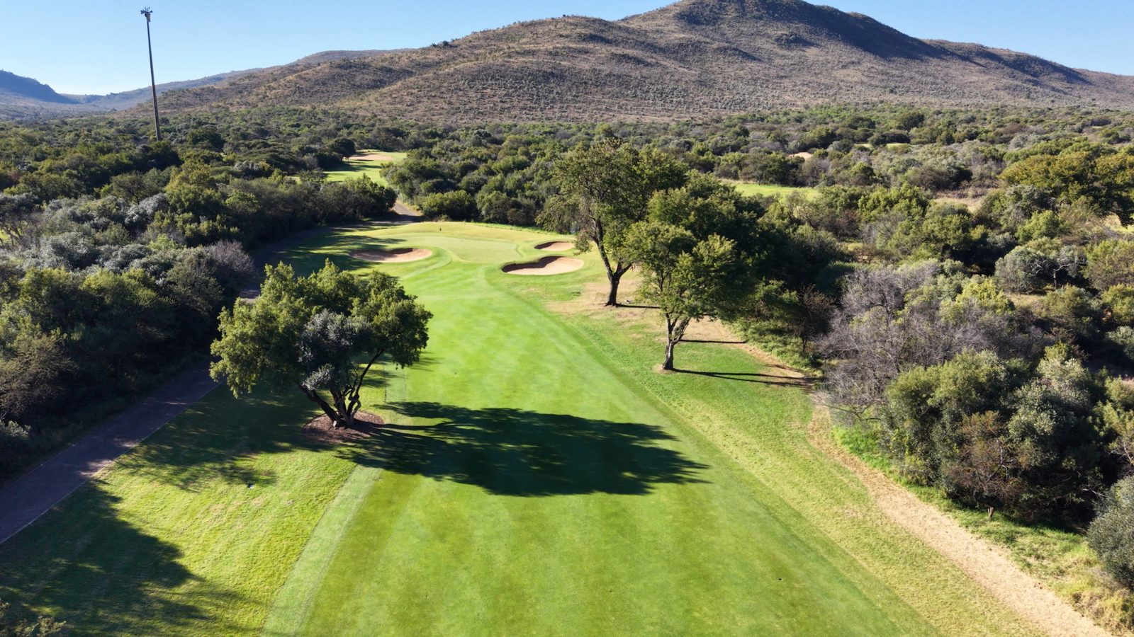 Golf green bordered by mountains