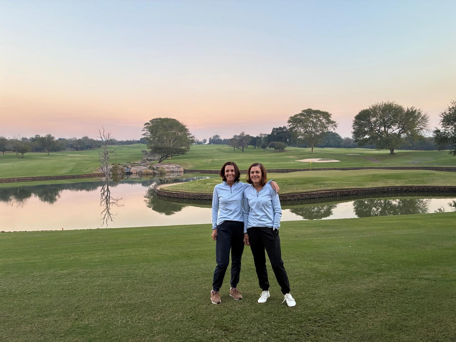 Two guests on the golf course at sunset