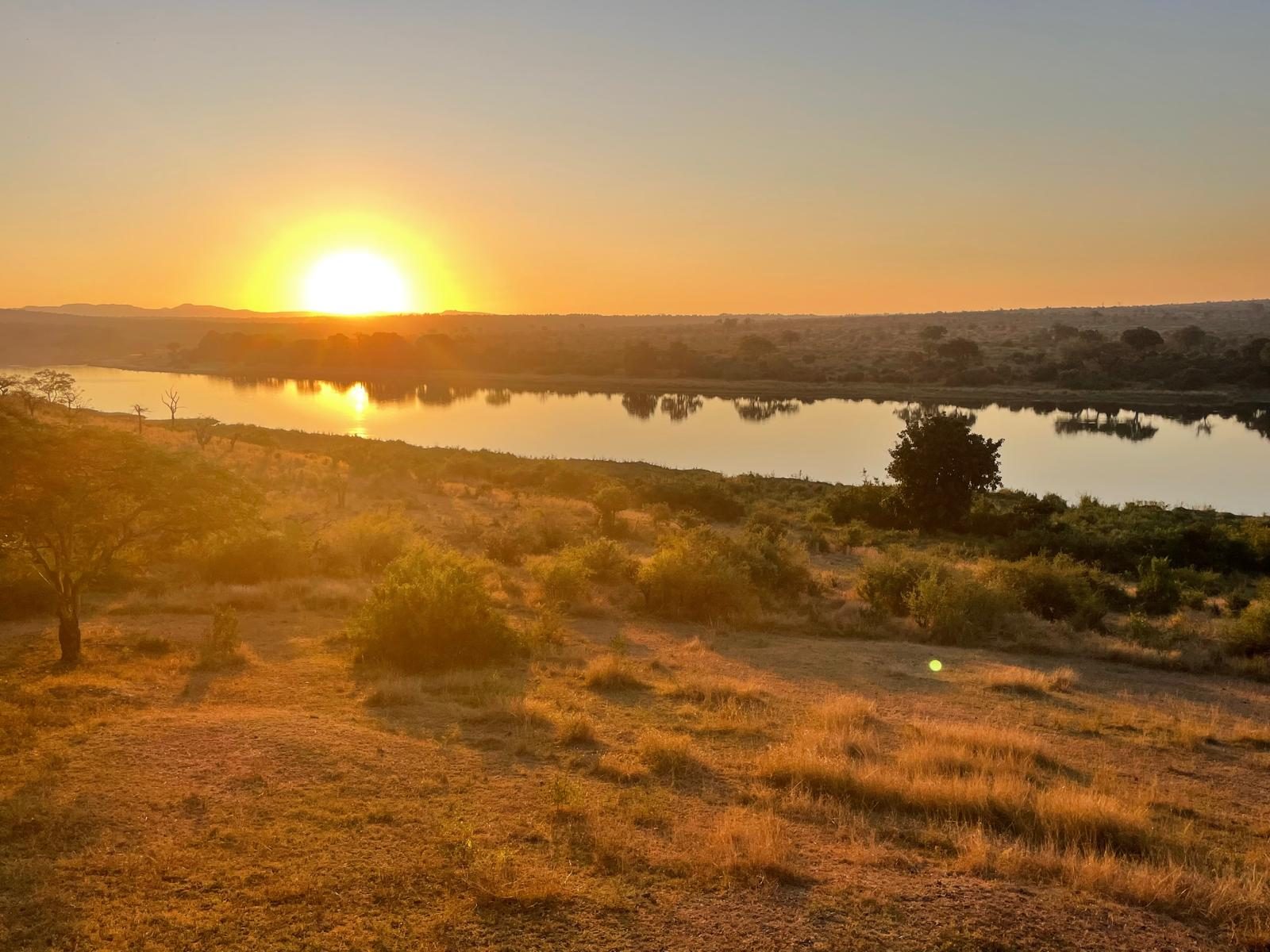 Sunset over a river in the South African bushveld